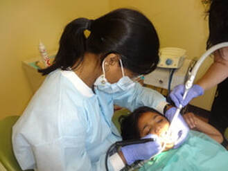 Dr. Sudha treating a patient at CosmicSmiles Dental